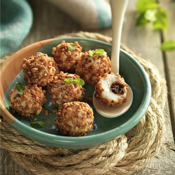 Cheese balls filled with tapenade and coated with almond