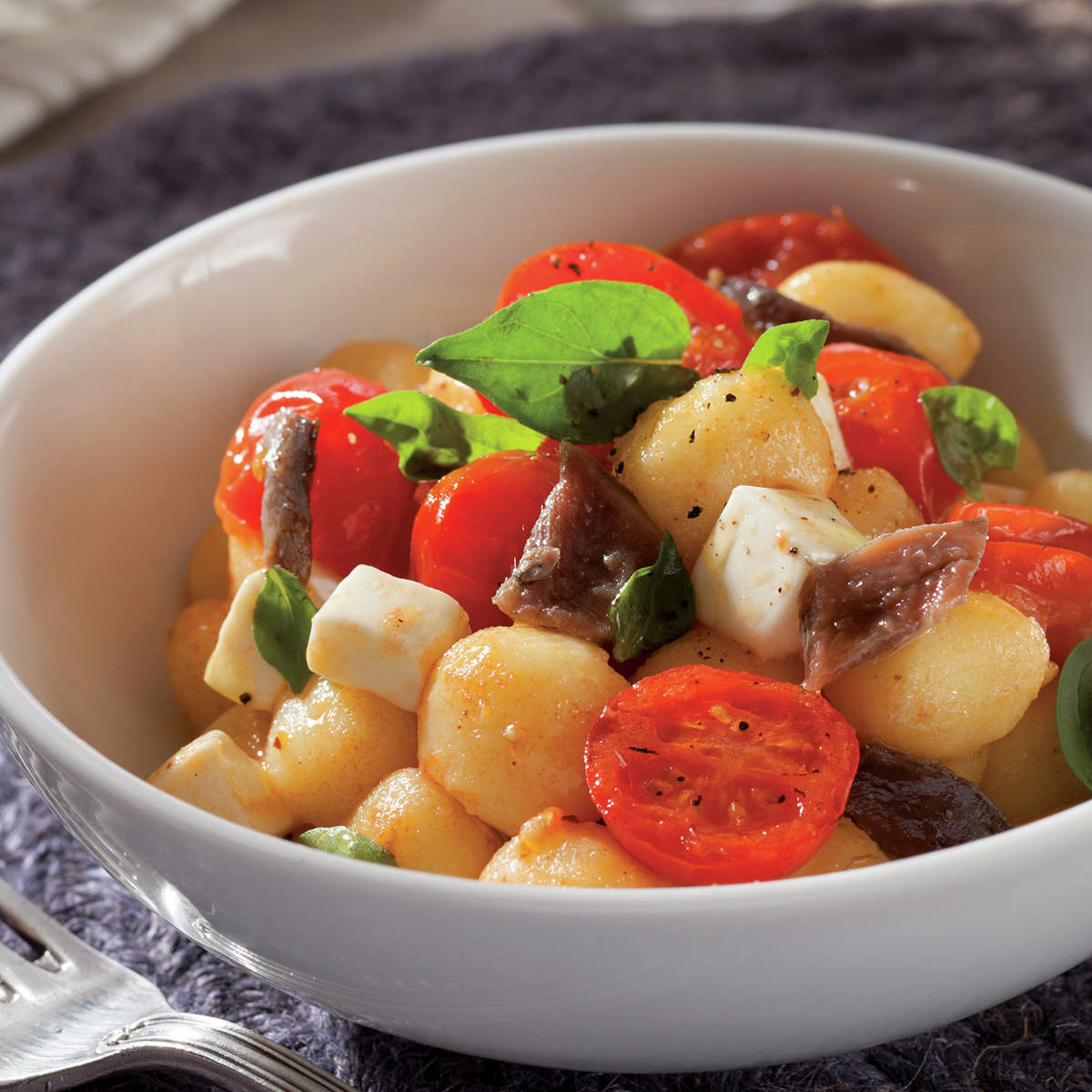 Ñoquis con queso, tomatitos y anchoas